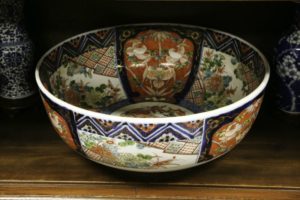 Porcelain bowl with colored geometric and floral designs on both its interior and exterior surfaces