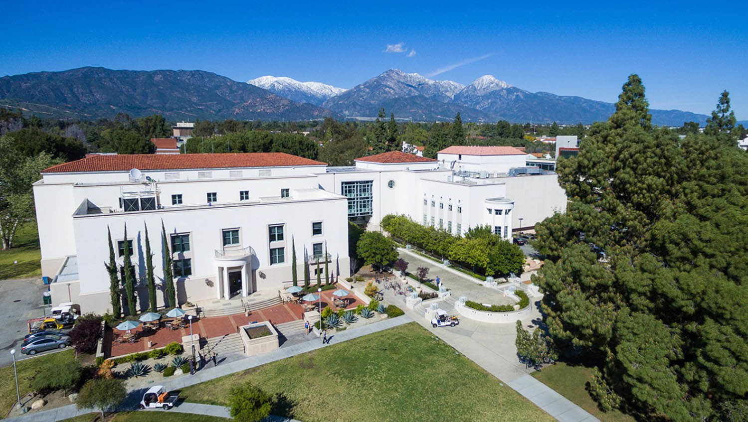 an aerial view of the library building with the mountains and sky behind it.