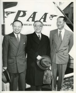 A picture of Chen Shou-yi (left) and Hu Shih(middle) taken in front of a Pan American World Airways sign.