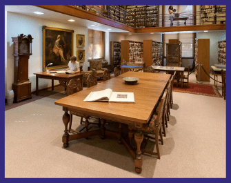 Photo of Special Collections Reading Room with student at a table reading