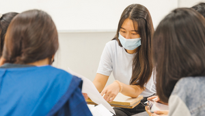 group of students studying together wearing masks