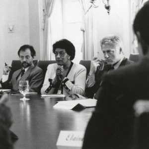 Photo of Myrlie Evers-Williams at table with President Bill Clinton
